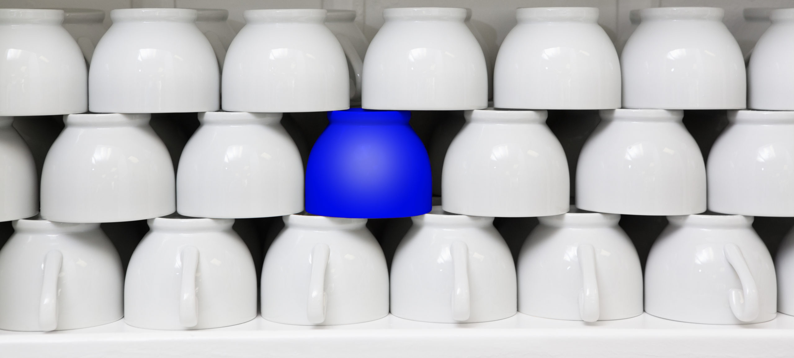 Blue Cup Amid White Coffee Cups